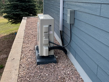 Viking Mechanical employee checking a residential air-conditioning unit.